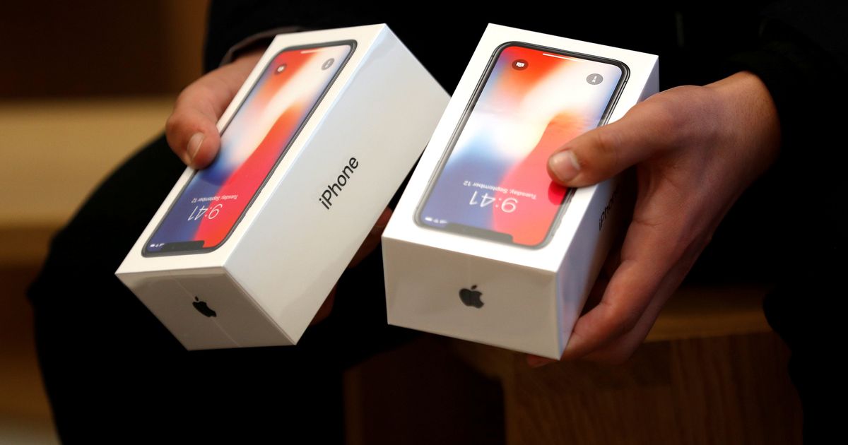 FILE-PHOTO-A-man-holds-two-boxes-for-the-Apples-new-iPhone-X-at-the-Apple-Store-in-Regents-Street